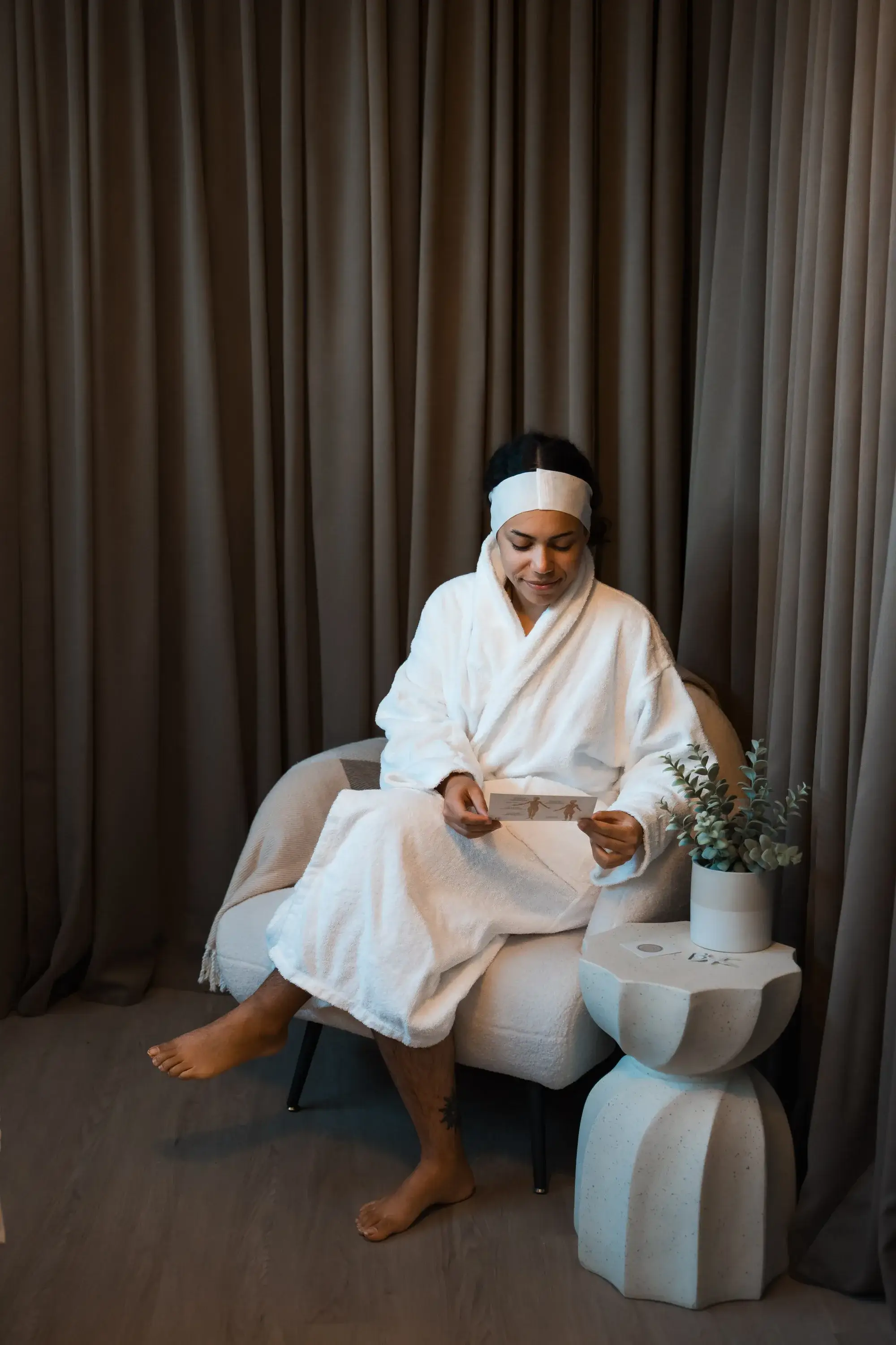 A client in a white robe resting in the BodyTox room
