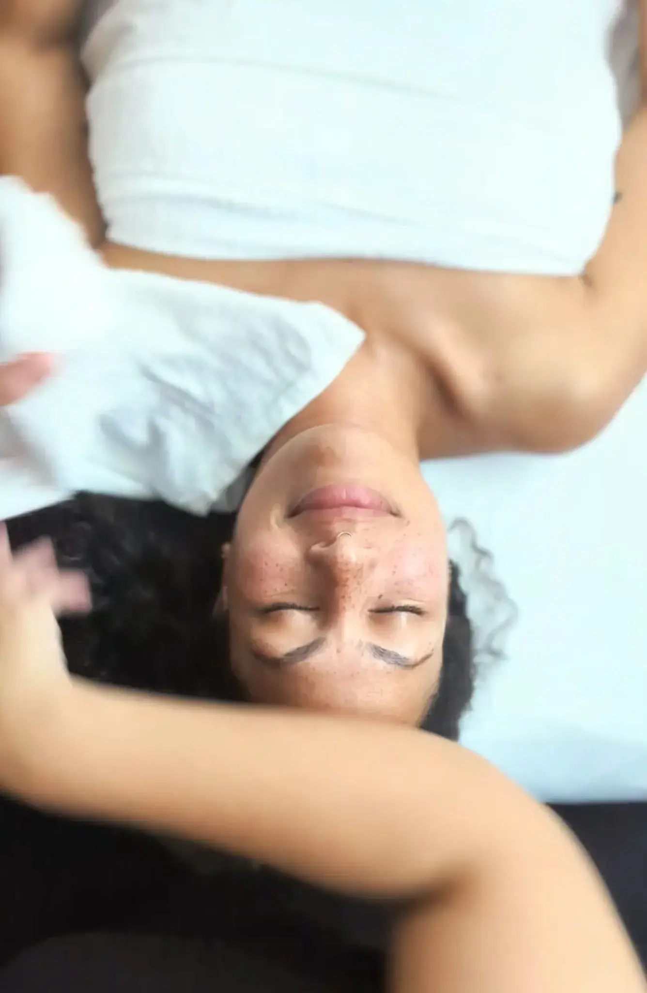 A client wrapped in a towel resting during the Silk Express facial