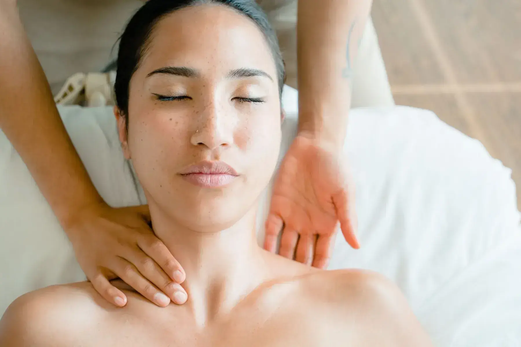 Gentle lymphatic strokes along a client's jaw and neck during a lymphatic facial at BodyTox by Renu