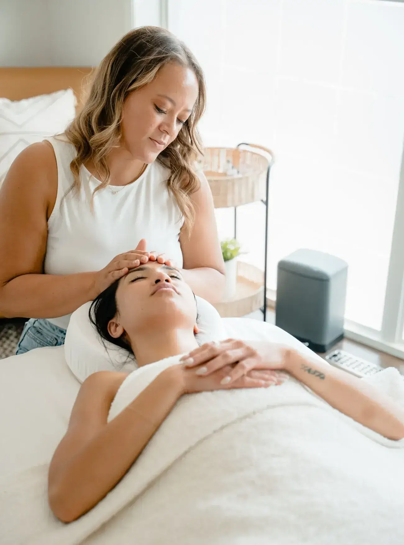 A therapist cradling a client’s head during a relaxation massage