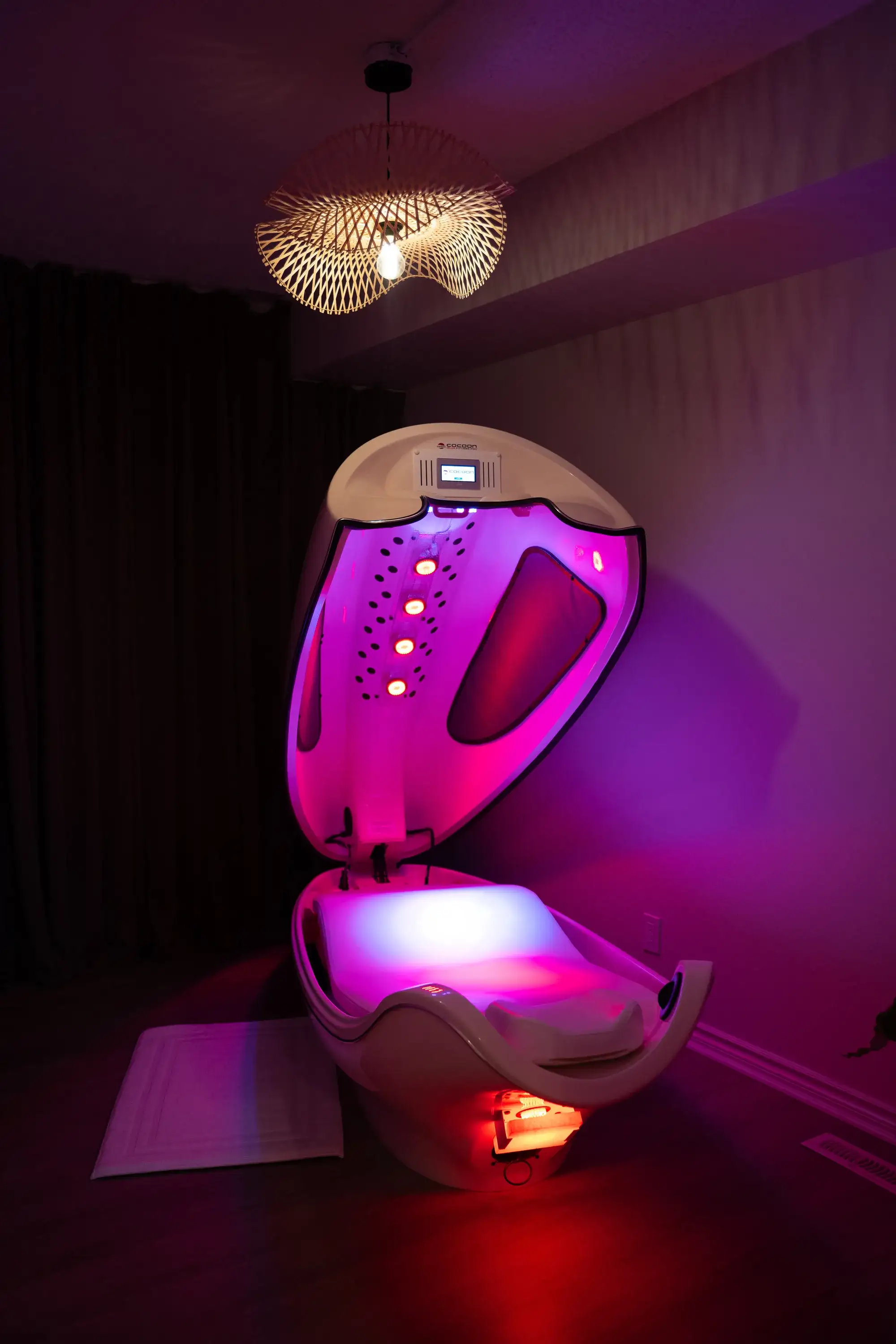 The infrared cocoon wellness pod glowing in its private room at BodyTox by Renu